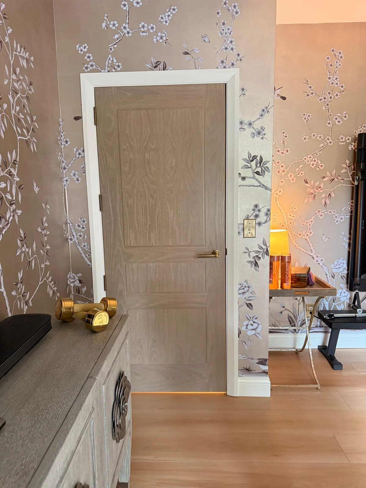 A door set against chinoiserie wallpaper
