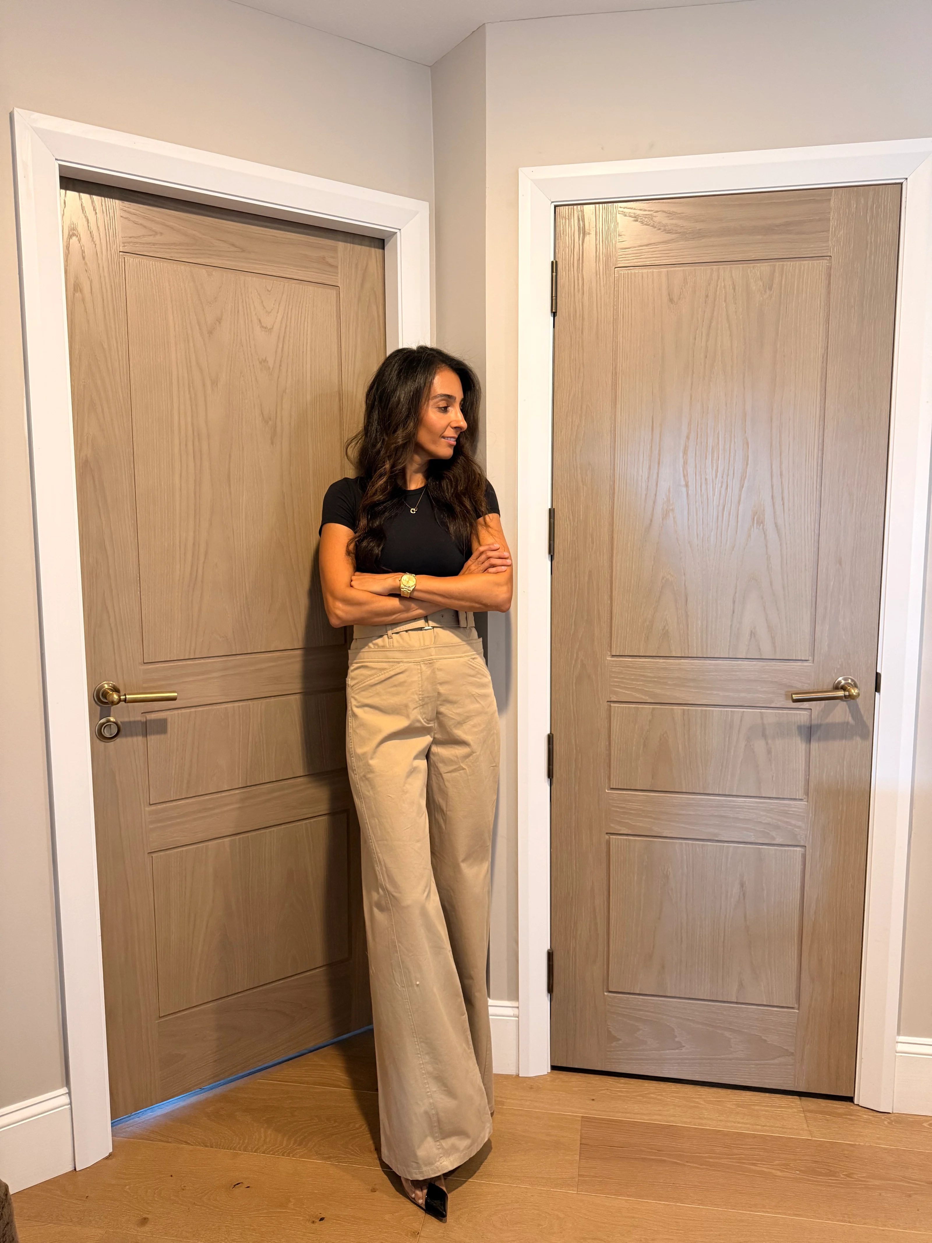 Farah Merhi standing at a Detroit Model door