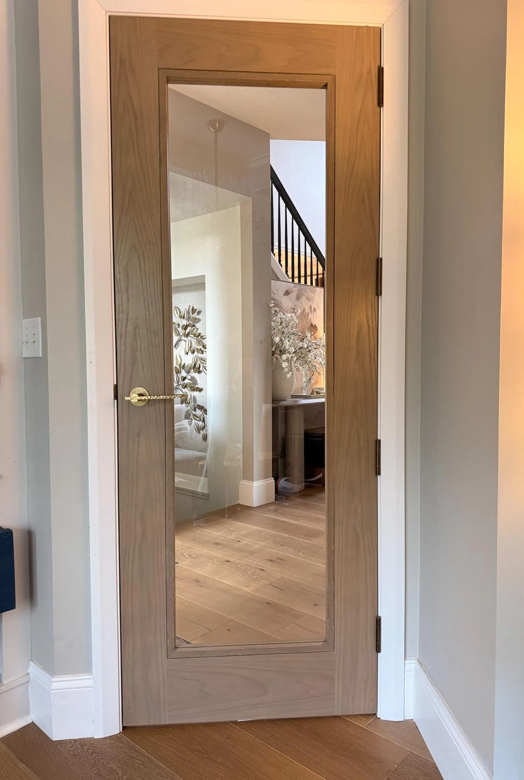A glazed door opening onto a hallway and staircase