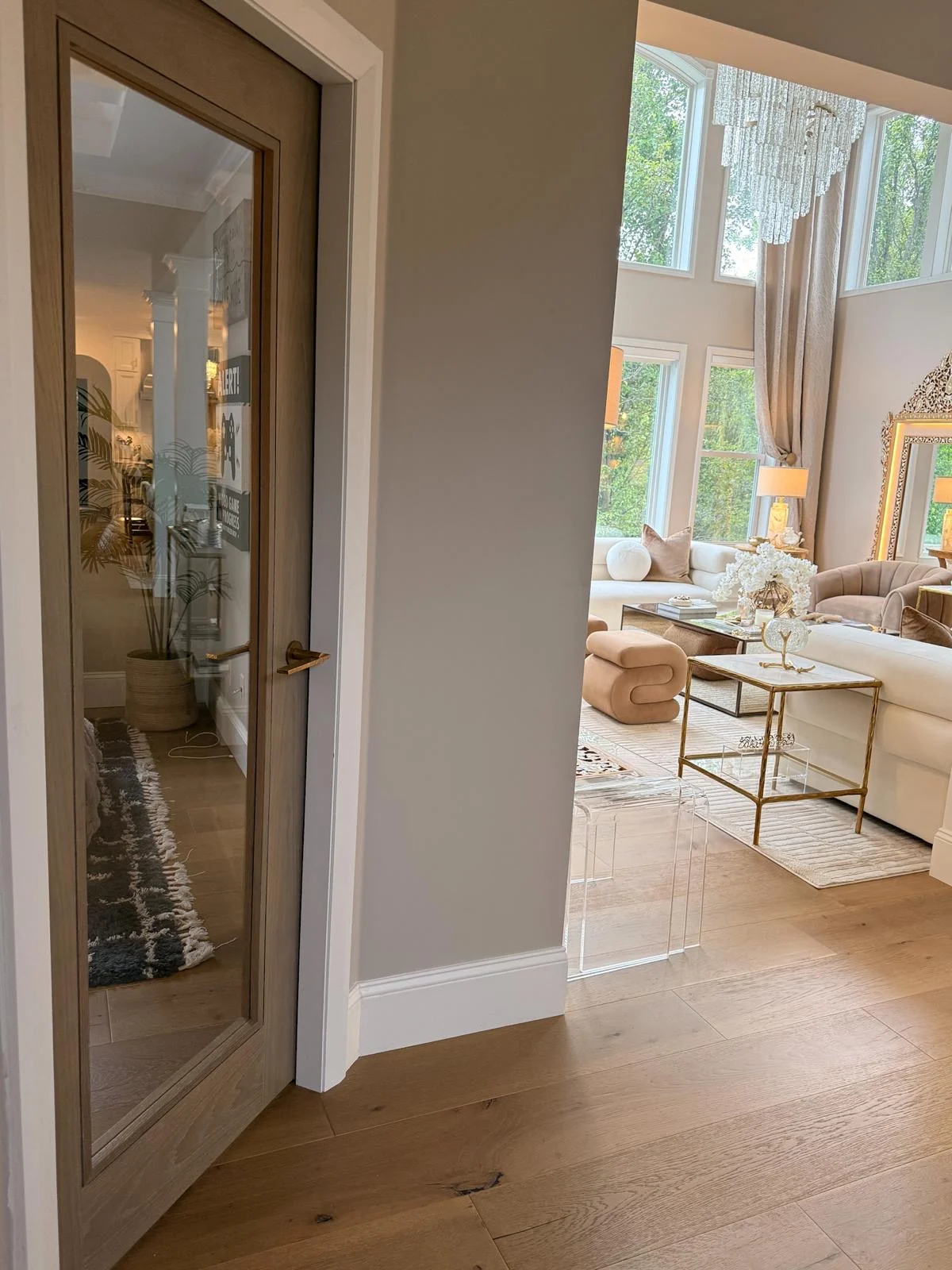 A hallway opening into the living room through a bespoke door
