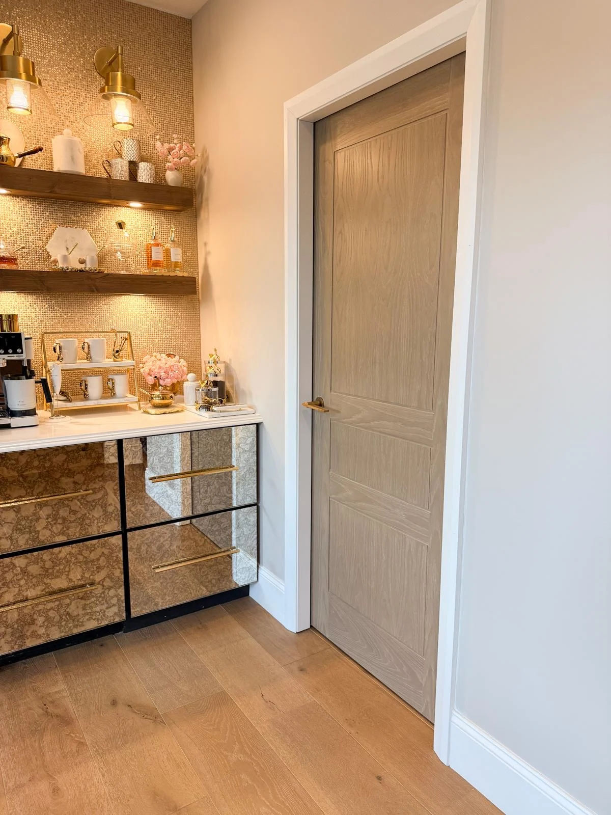 A panelled door in a warmly lit pantry