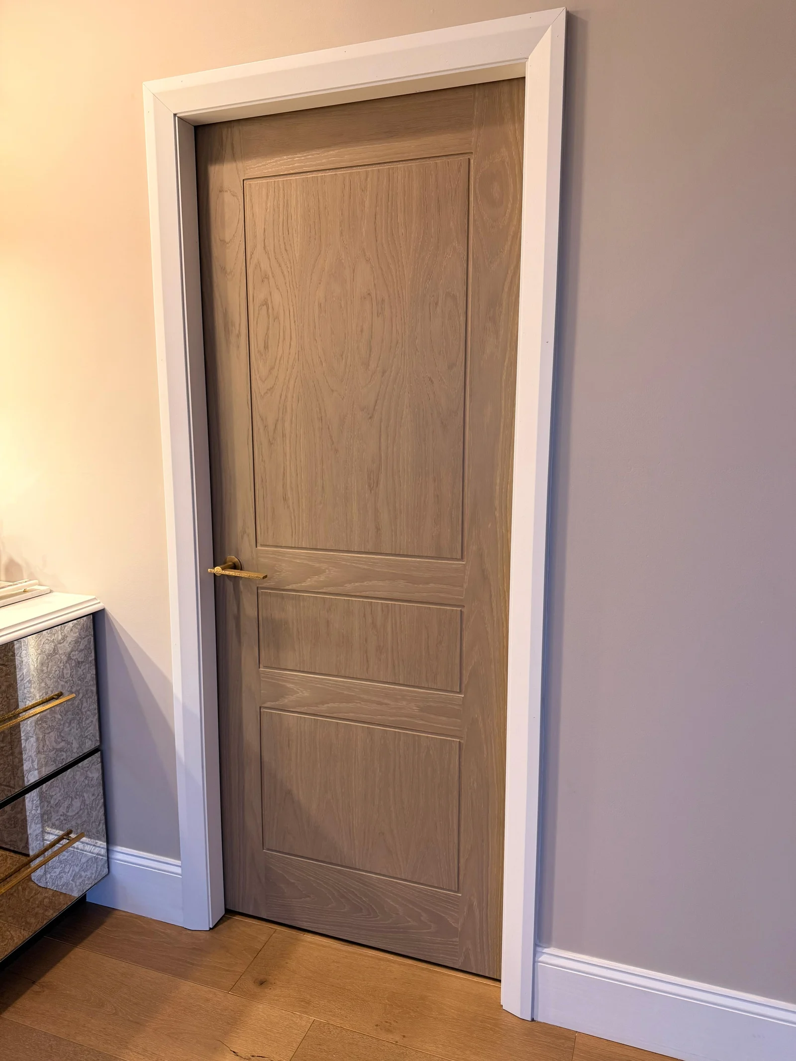 A three-panel door set in a painted solid wood frame